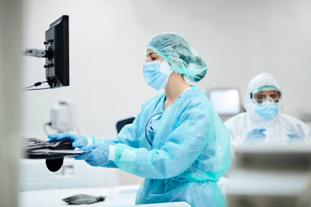 istock Nurse Working on Computer in ICU During Pandemic 1265186494
