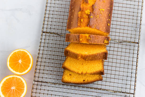 istock Orange Pound Cake in a Baking Loaf Pan on White Background Top Down Flat Lay horizontal Photo 1265187652