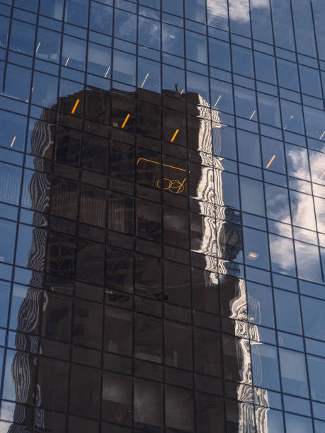 istock Abstract background with blurred reflections in mirrors. Abstract fragment of modern architecture, walls made of glass 1265188335