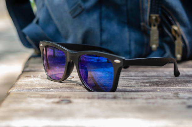 istock Sunglasses lie on a wooden park bench. 1265189268