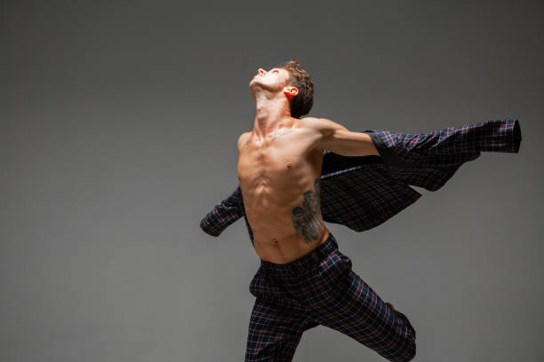 istock Cool young guy dancer in suit dancing in studio. Dance school poster. Break dance lessons 1265190390