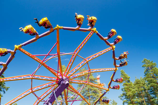 istock Extreme ride in motion in amusement park at sunny day 1265191013