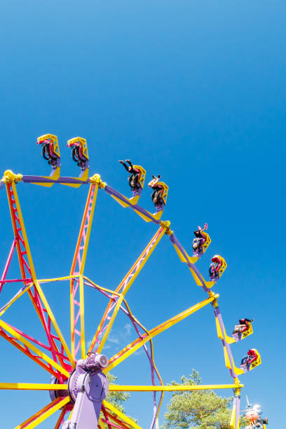istock Extreme ride in motion in amusement park at sunny day 1265191018