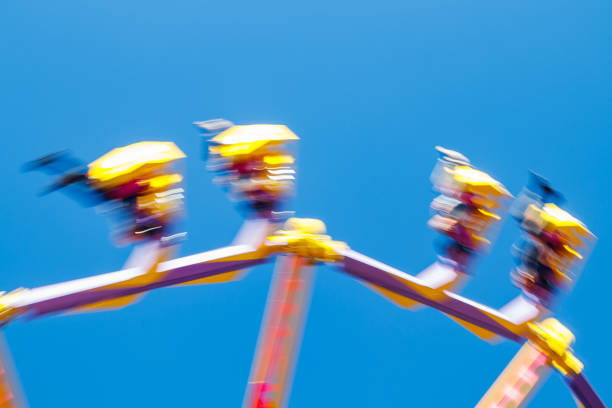 istock Extreme ride in motion in amusement park at sunny day 1265191021