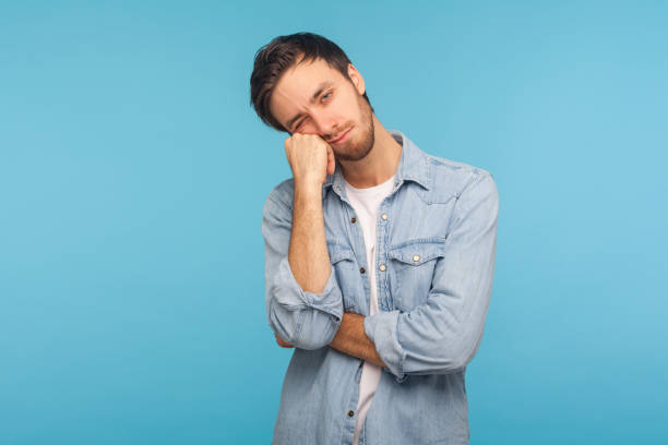 portrait of unhappy depressed man feeling bored with tedious conversation, looking at camera with disinterest - one person people boredom isolated imagens e fotografias de stock