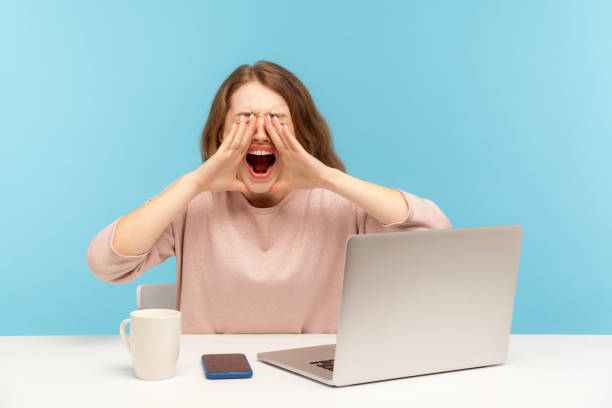 istock Stressful job. Depressed enraged young woman at workplace shouting with anger, feeling desperate hysterical lonely 1265192559