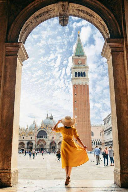 istock woman standing looking at saint marco piazza at sunny summer day 1265193628