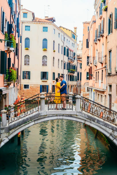 istock couple standing on the bridge crossing venice canals 1265193903