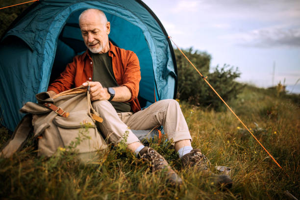 istock Senior hiker camping on the mountain 1265195435