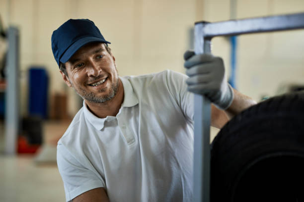 istock Happy auto repairman working in a car workshop. 1265200011