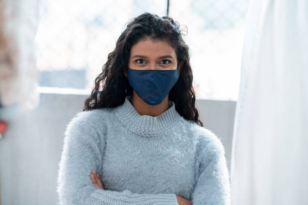istock Woman using her cell phone at home passing the COVID-19 quarantine 1265200363