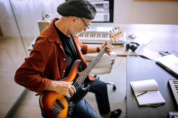 istock Senior rock guitarist with a guitar in his home studio 1265201385