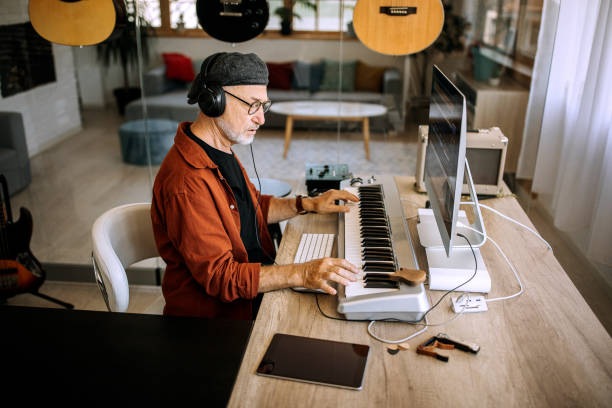 istock Senior musician playing on synthesizer 1265201403