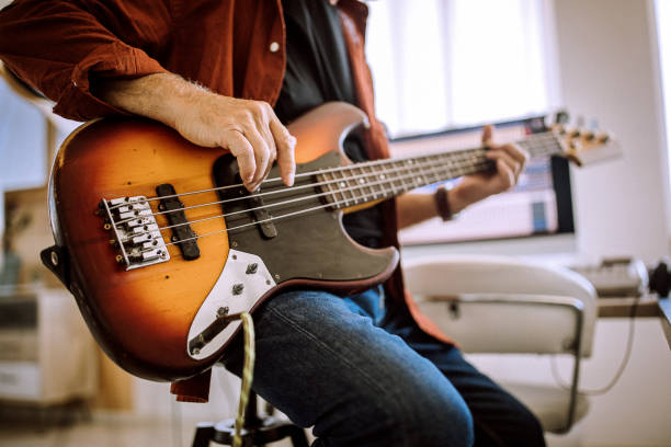istock Senior musician playing bass guitar in a music studio 1265201417