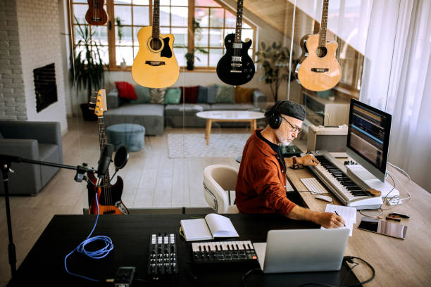 Senior musician writing in his home office studio