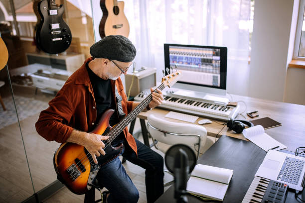 istock Senior rock guitarist playing guitar in his home studio 1265201443