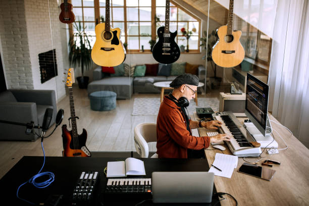 istock Senior musician playing on synthesizer 1265201482