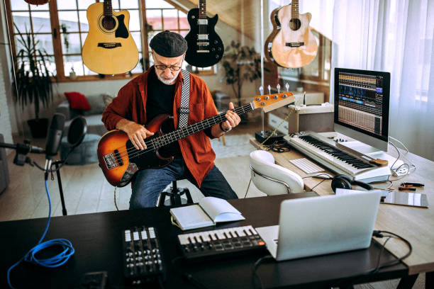 istock Senior rock guitarist playing guitar in his home studio 1265201556
