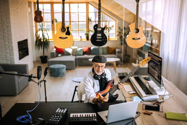 istock Senior music teacher giving online guitar classes 1265201653