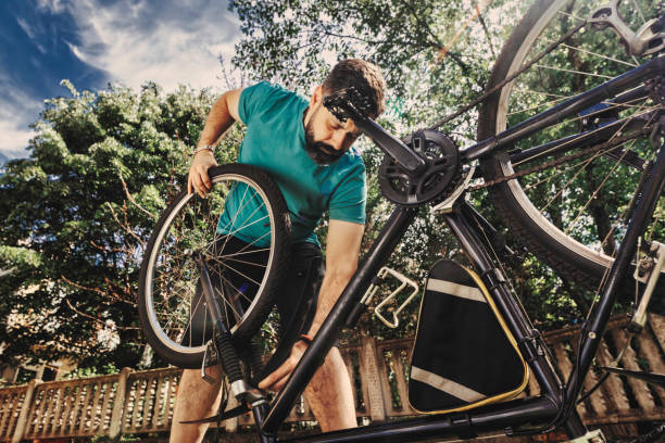 istock Man repairing bicycle DIY 1265201692