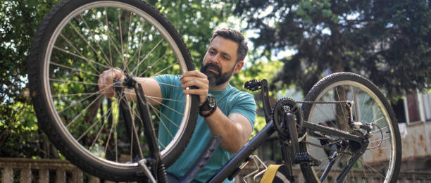 istock Man repairing bicycle DIY 1265201779