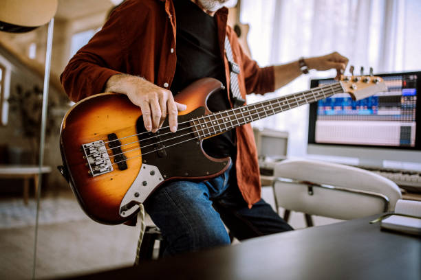 istock Senior rock guitarist playing guitar in his home studio 1265201780