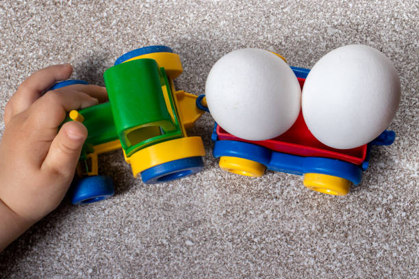 istock A toy tractor carries two chicken eggs. 1265202190
