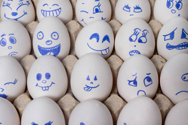 istock Funny chicken eggs. Smiley eggs with faces, funny faces. Eggs with different emotions: laughter, smiles, fear, anger, scream, tears. 1265202220