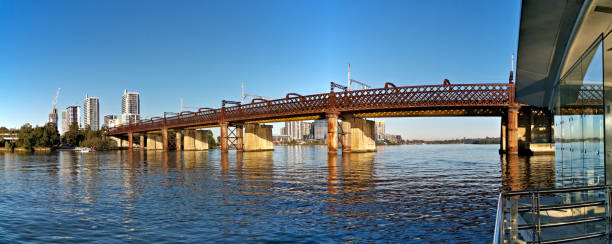 istock Beautiful panoramic view of a railway bridge over a river on a sunny day with deep blue sky 1265203022