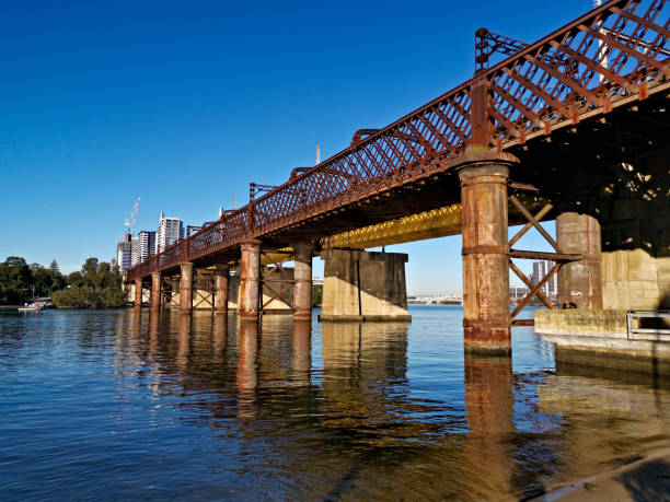 istock Beautiful view of a railway bridge over a river on a sunny day with deep blue sky 1265203095