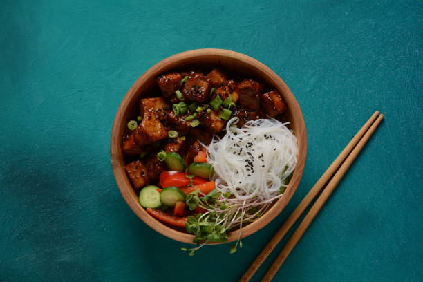 fried tofu with rice crystal noodles in a wooden bowl. - crystal noodles imagens e fotografias de stock