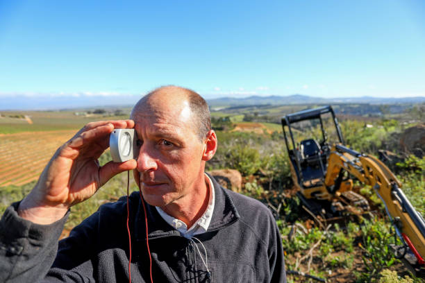 istock A man is using a clinometer while building a new mountain bike track. 1265204462
