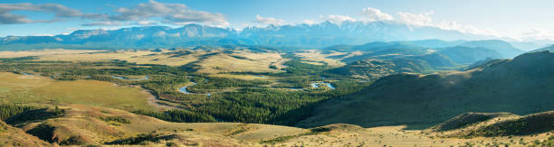 istock Scenic panoramic view, Altai mountains. Snow-capped peaks in blue haze, evening. 1265204641
