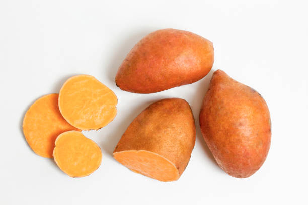 studio shot of orange sweet potatoes
