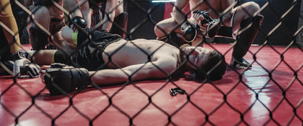 istock Knockout during martial arts training. Helping unconcious fighter 1265205654