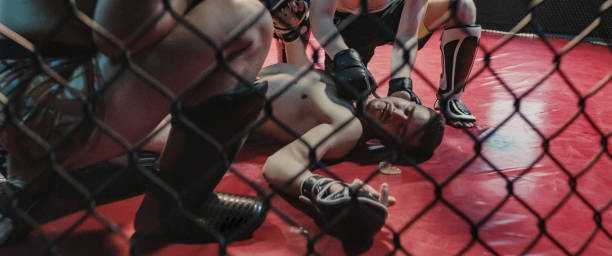 istock Knockout during martial arts training. Helping unconcious fighter 1265205668