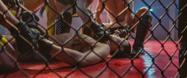 istock Knockout during martial arts training. Helping unconcious woman 1265205675