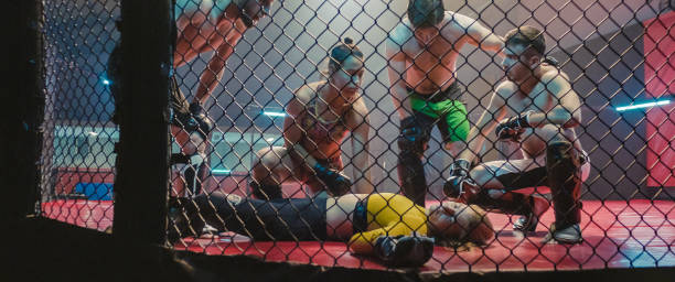 istock Knockout during martial arts training. Helping unconcious woman 1265205694
