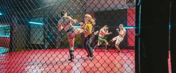 istock MMA fighters training in octagon. Two rough fights with kicks 1265205702