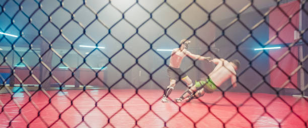 istock MMA ground fight in octagon. Throwing partner onto the mat 1265205716