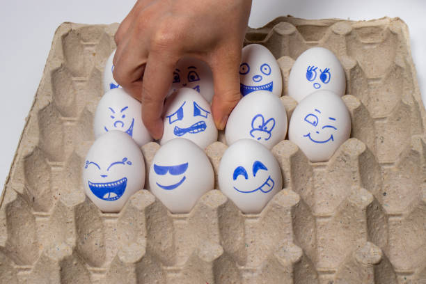 istock Funny chicken eggs. Smiley eggs with faces, funny faces. Eggs with different emotions: laughter, smiles, fear, anger, scream, tears. 1265206027