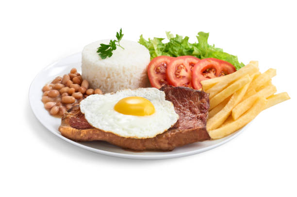 Executive counter filet dish with rice, beans, salad, chips and fried egg Executive counter filet dish with rice, beans, salad, chips and fried egg, view from below beans and rice stock pictures, royalty-free photos & images