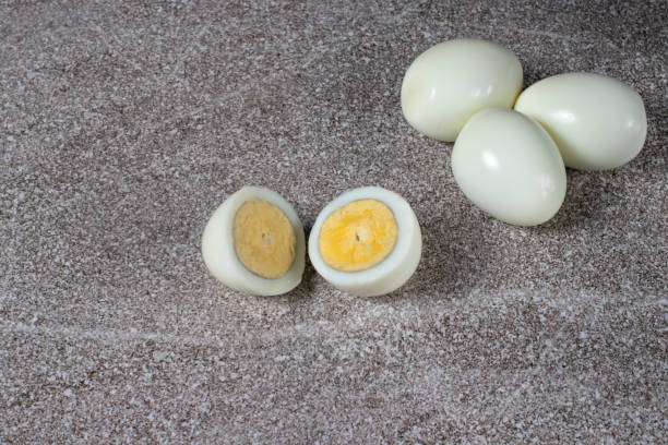 istock Boiled peeled eggs without shell on a gray background. Ingredients for cooking. 1265206190