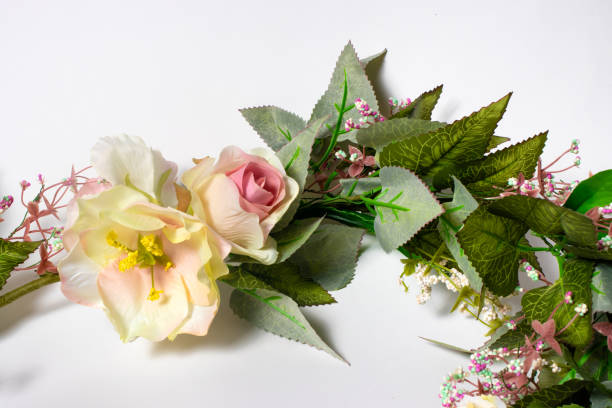 istock Artificial flowers on a white background. Pink and yellow roses. 1265206274