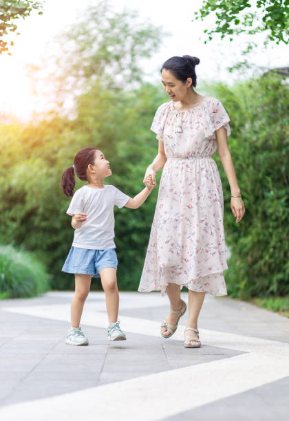 istock Mom and daughter walking and talking 1265208781