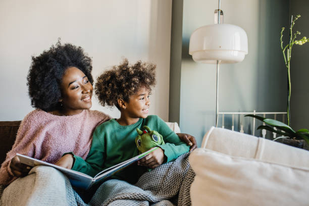istock Young mother is reading a book to her daughter 1265208963