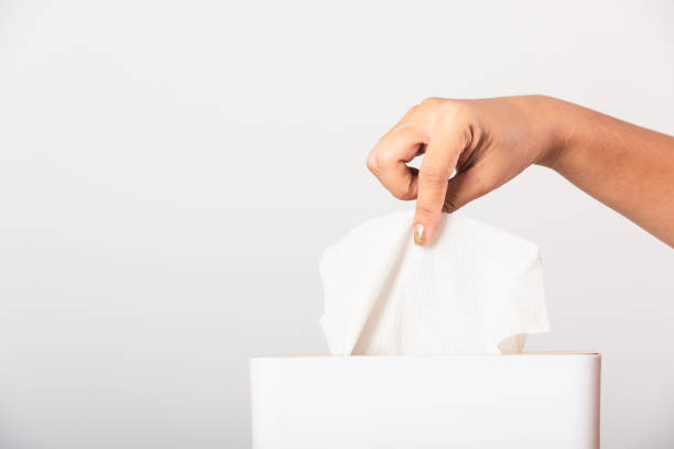 istock Hand taking pulling white facial tissue out of from a white box 1265209158