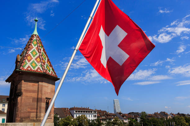 istock Swiss flag against blue sky 1265209217