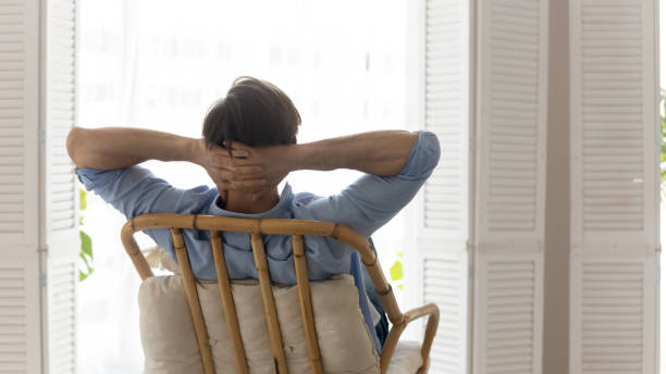 istock Rear view dreamy calm young man relaxing on cozy chair 1265210551