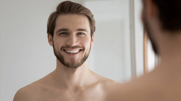 istock Head shot portrait mirror reflection smiling bearded young man 1265210566